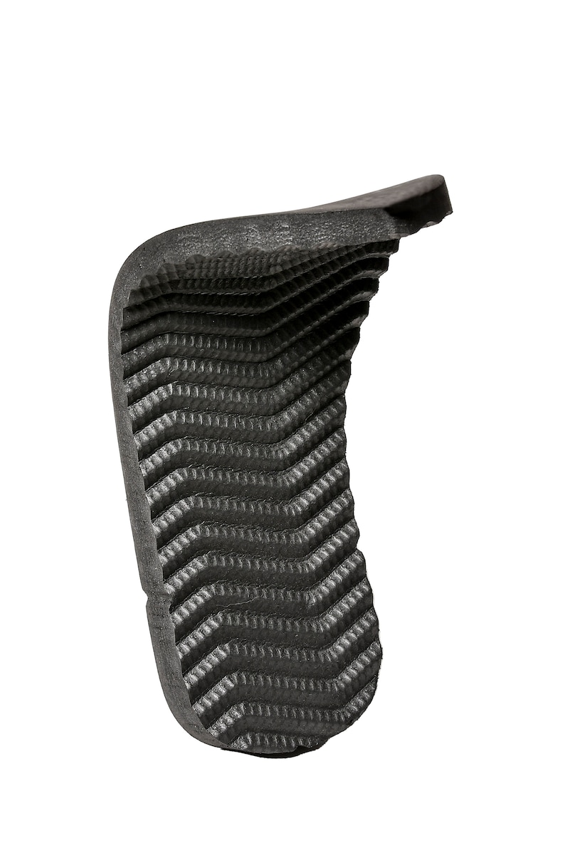 May include: Black rubber grip with a textured surface. The grip is designed to provide a secure and comfortable hold.