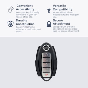 May include: A black key fob holder with a silver Nissan logo and five buttons. The holder is designed to securely attach to a car's interior using 3M double-sided tape.