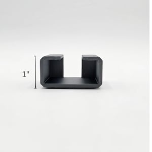 May include: A black plastic U-shaped bracket, measuring 2.5 cm in height.