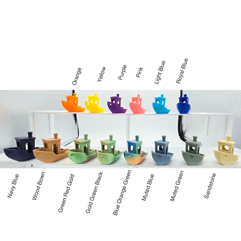 May include: A collection of 14 miniature toy boats in various colors, including navy blue, wood brown, green red gold, gold green black, blue orange green, muted blue, muted green, sandstone, orange, yellow, purple, pink, light blue, and royal blue.