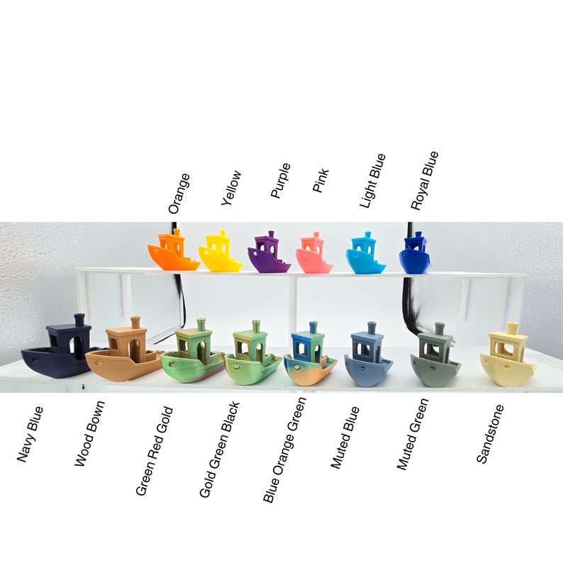 May include: A collection of small, colorful boat models in various shades including orange, yellow, purple, pink, light blue, and royal blue. Additional colors are navy blue, wood brown, green red gold, gold green black, blue orange green, muted blue, muted green, and sandstone.