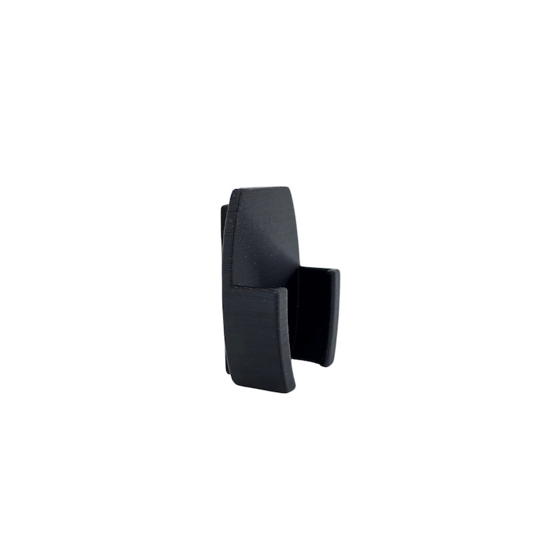 May include: A black plastic phone holder with a curved design.