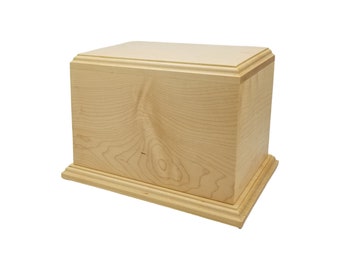 May include: A simple, natural wood cremation urn with a light wood finish. The urn has a rectangular shape with a slightly raised base and lid.