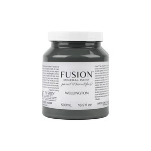 May include: A jar of Fusion Mineral Paint in the color Wellington, a dark gray. The jar has a white lid and the label includes the text "paint it beautiful" and "500mL 16.9 fl oz".