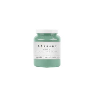 May include: A teal-colored paint jar with a white lid. The label reads "Alchemy, A blend of Limestone & Chalk, Juniper, Paint by Fusion". The jar is filled with a light teal paint, perfect for home decor and craft projects.