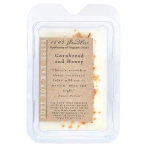 May include: A rectangular wax melt package with a label that reads "Cornbread and Honey." The label includes text and a quote. The wax is off-white with brown flecks, encased in a clear plastic clamshell.