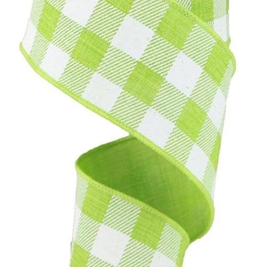 May include: A roll of green and white buffalo plaid ribbon. The ribbon is 2.5 inches wide and has a wired edge.