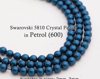 May include: Strands of Swarovski 5810 Crystal Pearls in Petrol (600). The beads are a deep teal color and are available in sizes ranging from 2mm to 12mm. The image shows multiple strands of the beads.