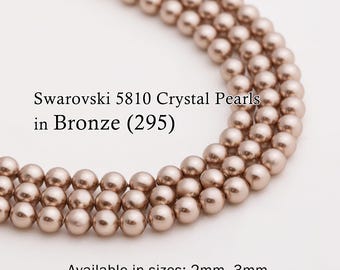 以下が含まれることがあります： ブロンズ（295）のSwarovski 5810クリスタルパールをクローズアップ。画像には、丸いブロンズ色のビーズが複数連なっています。サイズは2mmから12mmまであります。ジュエリー作りやクラフトに最適です。