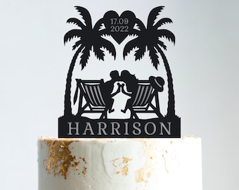 May include: Black silhouette cake topper of a couple kissing under palm trees with a heart that says "17.09.2022" and the name "HARRISON" below.