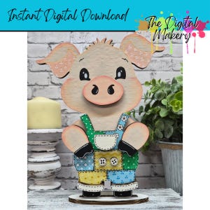 May include: A wooden pig figurine with a light pink face, ears, and snout, wearing patchwork overalls with button details. The text "Instant Digital Download" and "The Digital Makery" are visible at the top. The pig is standing on a wooden base.