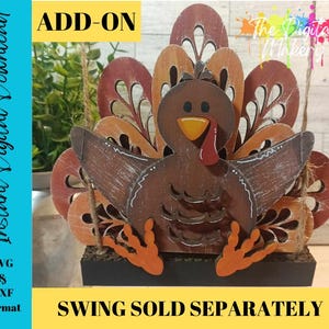 May include: A layered wooden turkey cutout featuring brown, orange, and red tones with a yellow beak and red wattle. The design includes intricate cutouts on the tail feathers and is mounted on a black base. Text includes ADD-ON, SWING SOLD SEPARATELY, and Instant Digital Download SVG & DXF Format.