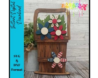 May include: A wooden cutout of a basket with red, white, and blue flowers. The basket is brown with a wood grain texture. The flowers have white centers and are layered in the basket. The basket has a handle and a base.