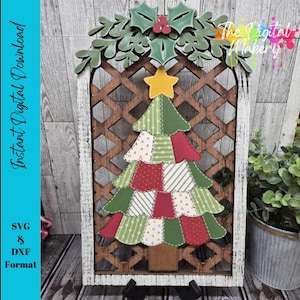 May include: Wooden Christmas tree decoration with a patchwork design in green, red, and white. The tree is set within a white-framed window with a lattice pattern. A yellow star tops the tree, and holly leaves and berries are at the top. Text on the left says "Instant Digital Download".