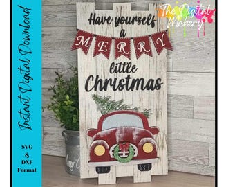 May include: A white wooden sign with the text "Have yourself a Merry little Christmas" in black lettering. A red truck with a Christmas wreath on the front is depicted below the text. The sign is decorated with red and white bunting.
