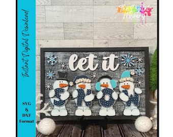 May include: A wooden sign with the words "let it" and four snowman figures holding the letters "O, W, S, and N". The snowmen are wearing hats and earmuffs. The sign is decorated with snowflakes and is in a black frame.