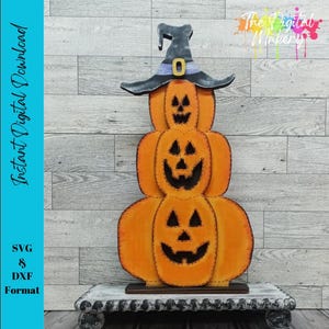 May include: A wooden Halloween decoration featuring three stacked orange pumpkins with carved jack-o'-lantern faces. A black witch's hat with a gold buckle sits atop the pumpkins. The words "Instant Digital Download" are visible.