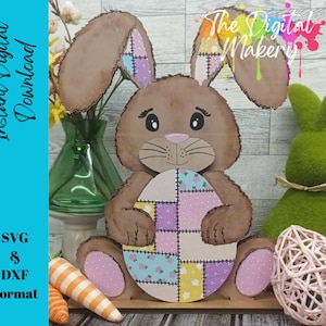 May include: A brown bunny rabbit holding a patchwork Easter egg. The bunny has a pink nose and brown eyes. The egg is decorated with a variety of colorful patches.