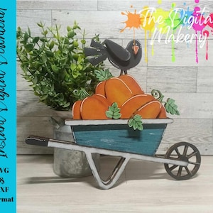 May include: A wooden wheelbarrow filled with orange pumpkins and a black crow perched on top. The wheelbarrow is painted blue and white, and the pumpkins have green leaves.