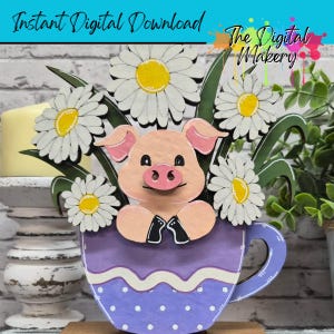 May include: A wooden decorative piece featuring a pig in a purple teacup with daisies. The pig has pink ears and a pink snout. The teacup has a white polka dot pattern and the text "Instant Digital Download" and "The Digital Makery".