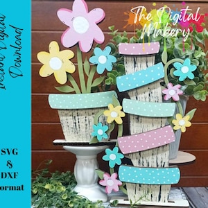 May include: SVG and DXF digital cut files for a layered flower pot craft project. The design features a stack of four flower pots with a distressed wood look and polka dot accents in pink, blue, and green. The pots are decorated with flowers in pink, yellow, and blue.
