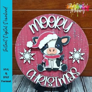 May include: A round, red wooden sign with the words "MOO-RY CHRISTMAS" in white, featuring a cartoon cow wearing a Santa hat and scarf. Two white snowflakes are on either side of the cow. The sign also includes the text "Instant Digital Download" and "SVG & DXF Format".