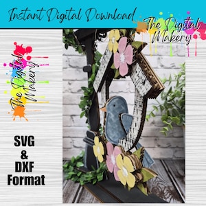 May include: A decorative birdhouse with a blue bird, yellow and pink flowers, and green leaves. The birdhouse has a distressed wood look. Text on the image reads "Instant Digital Download" and "The Digital Makery". The image also includes "SVG & DXF Format".