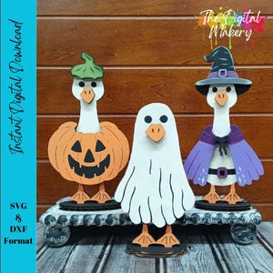 May include: Three Halloween-themed goose figurines. One is dressed as a pumpkin, another as a ghost, and the third as a witch. The figurines are made of wood and sit on a decorative stand. The image includes the text "Instant Digital Download".