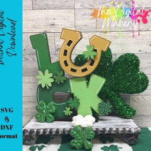 May include: A St. Patrick's Day themed decoration spelling out "LUCK" with a horseshoe and shamrocks. The letters are green, with a gold horseshoe and shamrocks. The decoration is on a white wooden stand. The image also includes the text "Instant Digital Download" and "SVG & DXF Format".