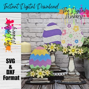 Może przedstawiać: Trzy dekoracje wielkanocne w kształcie jajek z kwiatowymi akcentami. Jajka są pomalowane różnymi wzorami i kolorami, w tym paskami, kropkami i zygzakami. Widoczny jest tekst "Instant Digital Download" i "The Digital Makery".