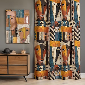 May include: A rectangular wall art piece and a floor-length curtain featuring a repeating pattern of stylized faces in shades of orange, yellow, black, and blue, accented with geometric shapes, stripes, and triangles on a textured fabric surface.