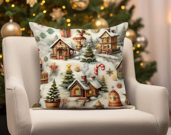 May include: A white throw pillow with a festive Christmas village design. The pillow features illustrations of houses, trees, and other holiday decorations in a snowy setting.
