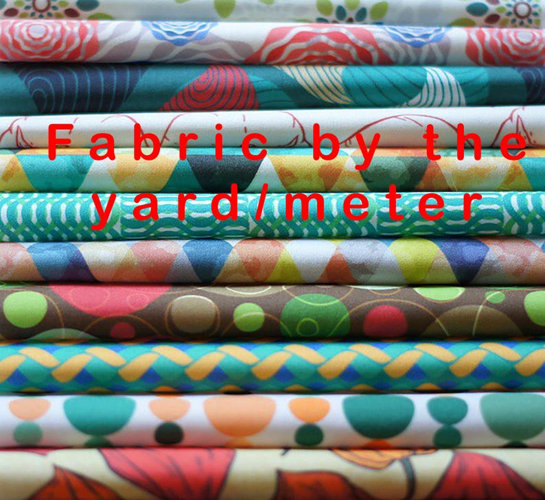 a stack of colorful fabrics with the words fabric by the yard