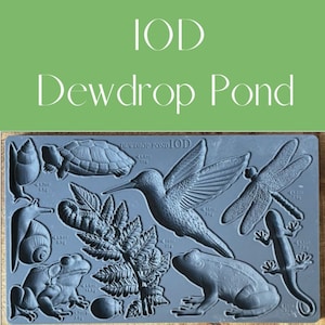 May include: A gray silicone mold with a hummingbird, dragonfly, frog, turtle, snail, and fern design. The mold is labeled "DEWDROP POND IOD".
