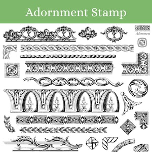 May include: A collection of black and white vintage style decorative stamp designs. The designs include borders, corners, swirls, and floral motifs. The text "Adornment Stamp" appears at the top of the image.