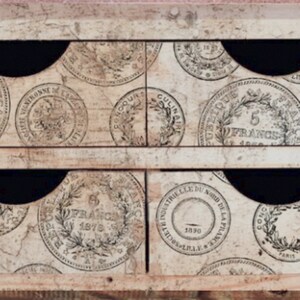 May include: A wooden box with six drawers, each decorated with a vintage French coin design. The drawers are labeled with the text "5 Francs 1874", "20 Francs 1876", "5 Francs", "5 Francs 1874", "5 Francs 1874", and "5 Francs 1874".