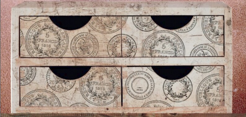 May include: A wooden box with six drawers, each decorated with a vintage French coin design. The drawers are labeled with the text "5 Francs 1874", "20 Francs 1876", "5 Francs", "5 Francs 1874", "5 Francs 1874", and "5 Francs 1874".