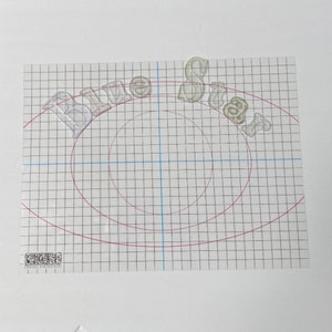 May include: A clear plastic sheet with a grid pattern and the words "Blue Star" printed in a semi-circle shape.