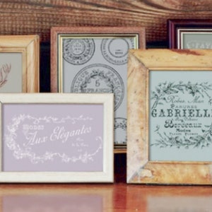 May include: A collection of six vintage-style picture frames in various colors and sizes. The frames are made of wood and have a distressed finish. The frames are arranged in a row on a wooden surface. The frames are empty, but they could be used to display photos, artwork, or other items.