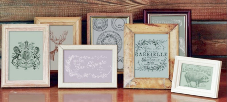 May include: A collection of six vintage-style picture frames in various colors and sizes. The frames are made of wood and have a distressed finish. The frames are arranged in a row on a wooden surface. The frames are empty, but they could be used to display photos, artwork, or other items.