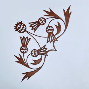 May include: A brown paper cut-out design of a stylized thistle plant with multiple flowers and leaves.