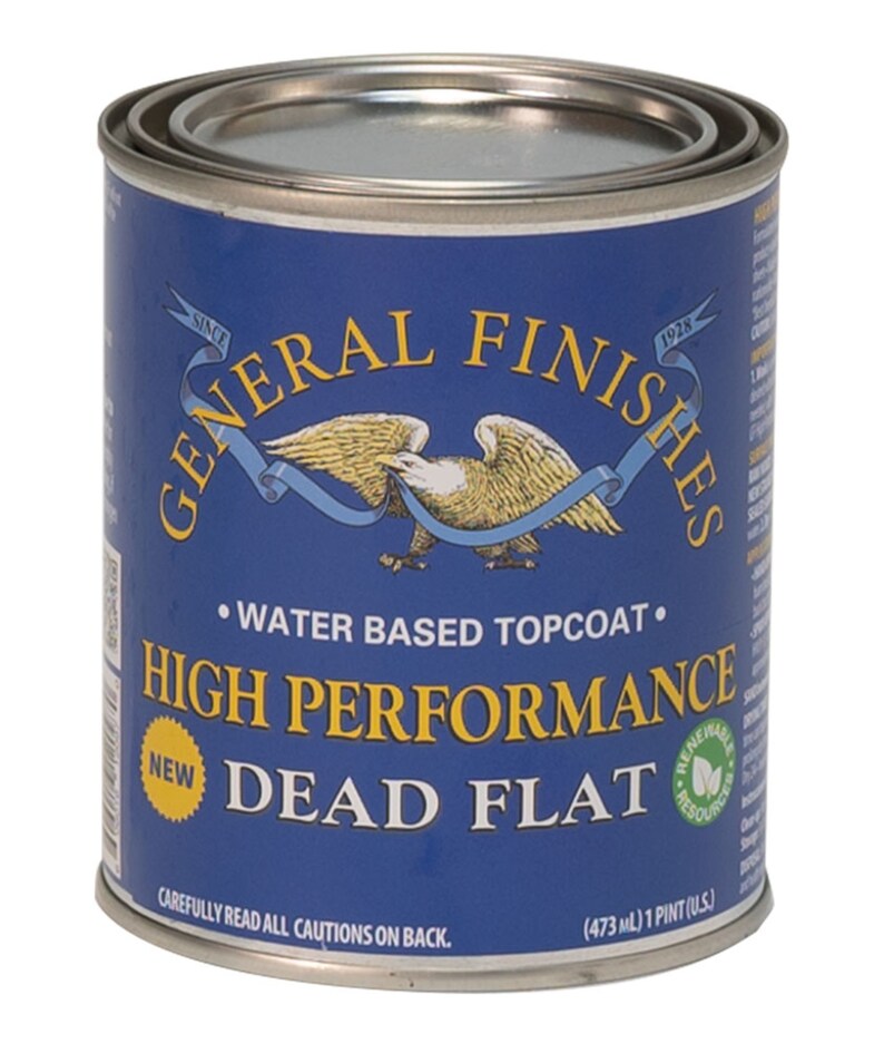 May include: A blue can of General Finishes High Performance Dead Flat water-based topcoat. The can has a gold eagle logo and the text "Since 1928" on it. The can is labeled "New" and has a green leaf logo that says "Renewable Resources". The can is 473 ml or 1 pint.