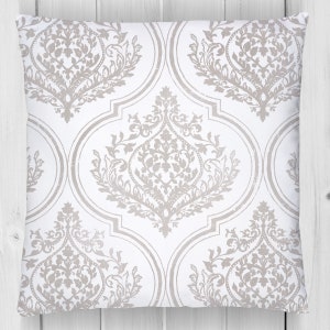 May include: A white throw pillow with a silver damask pattern. The pillow has a square shape and is made of a soft, comfortable fabric.