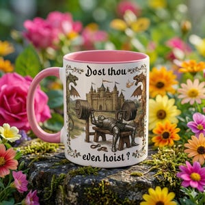 May include: A white ceramic mug with a pink interior and handle. The mug features a medieval-themed illustration of a knight lifting weights, with the text "Dost thou even hoist?" in a decorative font. The background is a garden.