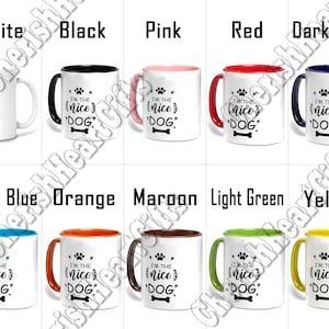 May include: Collection of ceramic mugs in various colors, each featuring the text "I'M THE nice DOG" with paw prints and a bone graphic. Colors include white, black, pink, red, dark blue, light blue, orange, maroon, light green, and yellow.