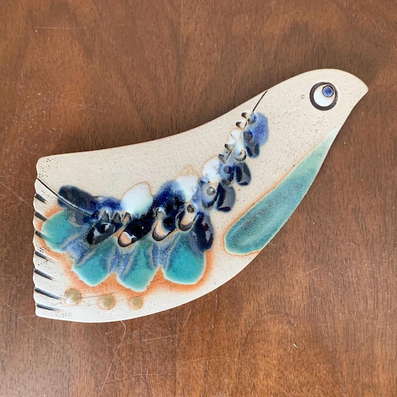 Hand-pinched ceramic birds with a folk-art soul and a MCM silhouette — the artist's name is on it and 12 people already love them.