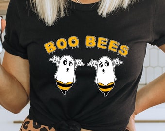 May include: Black t-shirt with a graphic of two ghosts dressed as bees. The text "BOO BEES" is above the ghosts.