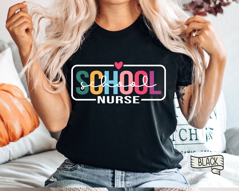 May include: A black t-shirt with a rainbow colored "SCHOOL NURSE" graphic and a small red heart above the text.