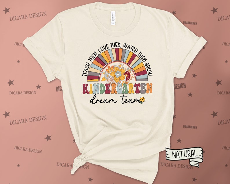May include: A beige t-shirt with a rainbow and floral design. The text "Teach them, love them, watch them grow" is written in a circle around the rainbow. The text "Kindergarten dream team" is written below the rainbow.