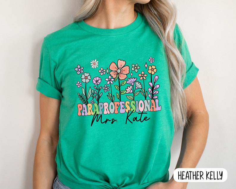 May include: Green t-shirt with a colourful floral design and the text "Paraprofessional Mrs. Kate".